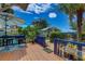Outdoor deck featuring table, chairs and an umbrella with a view of lush, tropical landscaping at 4742 13Th N Ave, St Petersburg, FL 33713