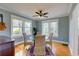 Cozy dining room featuring hardwood floors, a modern ceiling fan, and a round glass table with four chairs at 4742 13Th N Ave, St Petersburg, FL 33713