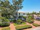 Charming two-story home with meticulously landscaped front yard, mature trees and inviting brick paved drive at 4742 13Th N Ave, St Petersburg, FL 33713