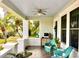 Inviting front porch with classic brick columns, comfortable wicker seating and serene garden views at 4742 13Th N Ave, St Petersburg, FL 33713