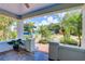 Relaxing front porch with tiled flooring, brick columns, and a view of the professionally landscaped front yard at 4742 13Th N Ave, St Petersburg, FL 33713