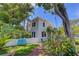 Charming home featuring a lush green front yard, brick pathway and a comfortable blue bench for relaxation at 4742 13Th N Ave, St Petersburg, FL 33713