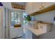 Bright laundry room features white cabinets and a view to the outside at 4742 13Th N Ave, St Petersburg, FL 33713