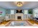 Comfortable living room features hardwood floors, a cozy fireplace, and built-in shelving for storage at 4742 13Th N Ave, St Petersburg, FL 33713