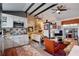 Charming living room with open floorplan, stylish accents, exposed beams and attached kitchen space at 4742 13Th N Ave, St Petersburg, FL 33713