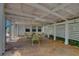 Covered patio with dining area and ambient lighting, surrounded by a privacy fence and lush plants at 4742 13Th N Ave, St Petersburg, FL 33713
