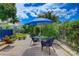Charming brick patio with an umbrella-covered table, surrounded by lush tropical landscaping at 4742 13Th N Ave, St Petersburg, FL 33713