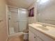 Well-lit bathroom with a vanity, sink, and a shower featuring a glass door, combining style and convenience at 4851 W Gandy Blvd # B12L23, Tampa, FL 33611