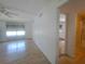 Bright bedroom with light wood floors and a ceiling fan with light fixture, offering a comfortable and serene space at 4851 W Gandy Blvd # B12L23, Tampa, FL 33611