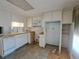 Functional kitchen with dated countertops, white cabinetry and natural light from large windows at 4851 W Gandy Blvd # B12L23, Tampa, FL 33611