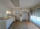 Functional kitchen with dated countertops, white cabinetry and natural light from large windows at 4851 W Gandy Blvd # B12L23, Tampa, FL 33611