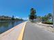 Stunning waterfront view with a paved walkway, beautiful landscaping, and serene water access at 4851 W Gandy Blvd # B12L23, Tampa, FL 33611