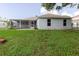 Exterior view of the home's backyard and screened in patio at 4959 Cromey Rd, North Port, FL 34288