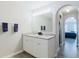 Bright bathroom with double vanity and granite countertops, leading to the main bedroom at 4959 Cromey Rd, North Port, FL 34288