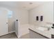 Bathroom featuring a soaking tub, granite countertop vanity, and a window offering plenty of natural light at 4959 Cromey Rd, North Port, FL 34288