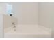 Large, tiled bathtub in a bright bathroom provides the perfect spot to relax at 4959 Cromey Rd, North Port, FL 34288