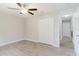 Bedroom features wood-look tile flooring, a ceiling fan, and a double-door closet at 4959 Cromey Rd, North Port, FL 34288