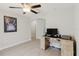 Bedroom featuring a ceiling fan and neutral paint, with wood-look tiling and a desk at 4959 Cromey Rd, North Port, FL 34288