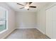 Bedroom featuring wood-look tile flooring, a ceiling fan, and a bright window at 4959 Cromey Rd, North Port, FL 34288