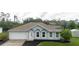 Charming single-story home with manicured landscaping, attached garage, and freshly painted exterior at 4959 Cromey Rd, North Port, FL 34288