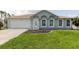 Charming one-story home with well-manicured lawn and a two-car garage, providing a welcoming curb appeal at 4959 Cromey Rd, North Port, FL 34288