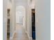 Hallway with arched doorway to other rooms, closet and tile flooring at 4959 Cromey Rd, North Port, FL 34288