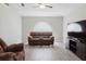 Cozy living room with ceiling fan and plush seating area for relaxing and entertaining at 4959 Cromey Rd, North Port, FL 34288