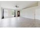 Bright living room with high ceilings, tile floors, two windows and a ceiling fan at 4959 Cromey Rd, North Port, FL 34288