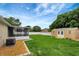 Expansive backyard featuring a screen porch, a storage shed and ample green space, perfect for outdoor activities and relaxation at 5015 Summer Hill Dr, Zephyrhills, FL 33542