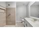 This bathroom features a spacious tile shower with stone floor and a modern vanity at 5015 Summer Hill Dr, Zephyrhills, FL 33542