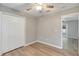 Bedroom featuring wood-look vinyl floors, a ceiling fan, and a paneled closet at 5015 Summer Hill Dr, Zephyrhills, FL 33542