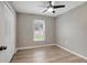 Bedroom with wood-look vinyl floors, a ceiling fan, and paneled bifold closet doors at 5015 Summer Hill Dr, Zephyrhills, FL 33542