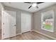 Bedroom with vinyl floors, a ceiling fan, and a paneled bifold closet door at 5015 Summer Hill Dr, Zephyrhills, FL 33542