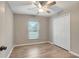 Bedroom with a window overlooking a lawn and a closet with paneled, bi-fold doors at 5015 Summer Hill Dr, Zephyrhills, FL 33542