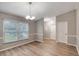 Bright dining area features updated flooring, new light fixture, fresh paint, and a large window at 5015 Summer Hill Dr, Zephyrhills, FL 33542