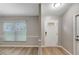 Entryway showcases modern flooring, neutral paint, updated doors, and a transom window over the front door at 5015 Summer Hill Dr, Zephyrhills, FL 33542