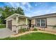 Inviting home featuring a well-manicured front yard, a front porch, and warm, neutral exterior tones at 5015 Summer Hill Dr, Zephyrhills, FL 33542