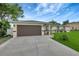 Charming single-story home with a two car garage, well-maintained landscaping, and a welcoming entrance at 5015 Summer Hill Dr, Zephyrhills, FL 33542