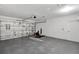 Spacious garage featuring durable epoxy floors, bright lighting, and ample storage space at 5015 Summer Hill Dr, Zephyrhills, FL 33542