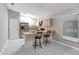 Modern kitchen with stainless steel appliances, updated cabinetry, a breakfast bar, and stylish light fixtures at 5015 Summer Hill Dr, Zephyrhills, FL 33542