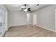 Open-concept living room features new flooring, ceiling fan, fresh paint, and an abundance of natural light at 5015 Summer Hill Dr, Zephyrhills, FL 33542