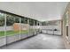 Enclosed patio with screened walls, overhead lighting and exterior view of yard and shed at 5015 Summer Hill Dr, Zephyrhills, FL 33542