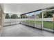 Enclosed patio with screened walls, overhead lighting and a lovely view of the lawn at 5015 Summer Hill Dr, Zephyrhills, FL 33542