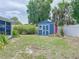 Backyard showcasing storage shed, tropical foliage, and full privacy fence at 5600 Hobson Ne St, St Petersburg, FL 33703