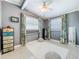 Bedroom featuring a ceiling fan, two windows, and stylish decor at 5600 Hobson Ne St, St Petersburg, FL 33703