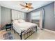 Bedroom featuring a ceiling fan, a bed with white covers, and gray walls at 5600 Hobson Ne St, St Petersburg, FL 33703
