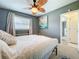 Bedroom featuring a ceiling fan, a bed with white covers, and gray walls at 5600 Hobson Ne St, St Petersburg, FL 33703