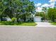 Charming single-story home with driveway, manicured lawn, and a one car attached garage, on a tree-lined street at 5600 Hobson Ne St, St Petersburg, FL 33703