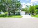 Inviting single-story home with a manicured lawn, driveway, white picket fence and attached one car garage at 5600 Hobson Ne St, St Petersburg, FL 33703