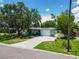 Well-maintained single-story home with a driveway, a white picket fence, and an attached one car garage at 5600 Hobson Ne St, St Petersburg, FL 33703